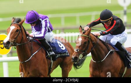 Le jet Setting, monté par Shane Foley (à droite), va gagner les Tattersalls Irish 1,000 Guinéas devant Minding, monté par Ryan Moore, au cours du deuxième jour du festival irlandais des Tattersalls Guinéas à l'hippodrome de Curragh. Banque D'Images