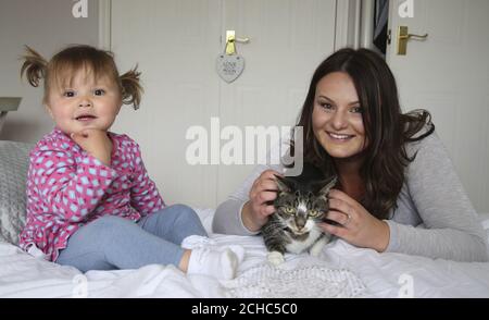 SOUS L'EMBARGO DU 0001 LUNDI 5 JUIN USAGE ÉDITORIAL EXCLUSIF de Sophie Hellyer avec sa fille avril, 22 mois, de Melksham, Wiltshire et de leur animal de compagnie Pixie, qui a été nommé dans la catégorie « Hero Cat » dans cette année et Otilde; Cats protection's National Cat Awards, sponsorisé par Purina. Banque D'Images