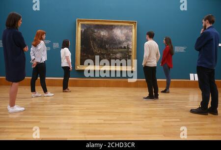 Le personnel de la galerie regarde la cathédrale de Salisbury de John Constable depuis les Meadows, 1831, lors d'un appel photo pour la nouvelle exposition de Tate Britain, Fire and Water, une exposition de Constable et Turner, à Londres. Banque D'Images