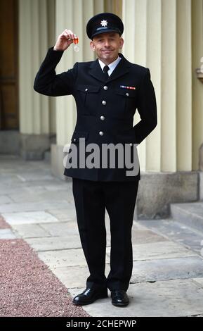 Le pompier Kevin Taylor avec la Médaille du service d'incendie de la Reine après une cérémonie d'investiture à Buckingham Palace, Londres. Banque D'Images