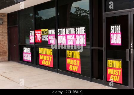 Plan incliné horizontal des fenêtres d'un magasin avec un plan de sortie des panneaux d'affaires en raison de la pandémie. Banque D'Images