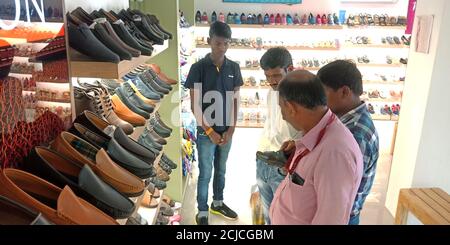 DISTRICT KATNI, INDE - 17 SEPTEMBRE 2019 : clients indiens achetant des chaussures dans la salle d'exposition. Banque D'Images