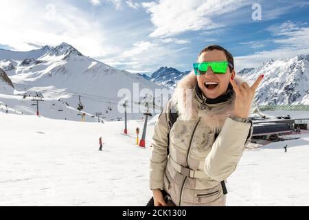 Jeune adulte belle heureuse attrayante caucasienne souriante randonneur femme bondissant saut haut comme une star contre la station de ski panorama à couper le souffle Banque D'Images