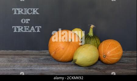 Trick or traite le texte de salutation sur bois sombre et tableau noir arrière-plan Banque D'Images