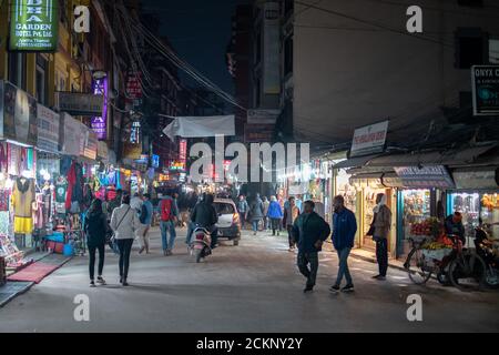 Thamel, Katmandou, Népal - décembre 22 2019 : des piétons non identifiés marchent dans les rues locales par des magasins éclairés la nuit dans la circulation Banque D'Images