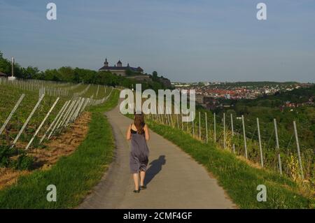 Femme marchant sur une route avec vue sur le paysage de Vineyard au château Marienberg à Wuerzburg Bavière, Allemagne Banque D'Images