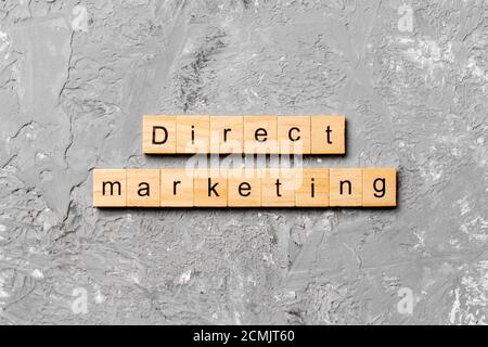 Mot de marketing direct écrit sur le bloc de bois. Texte de marketing direct sur la table de ciment pour votre conception, concept. Banque D'Images