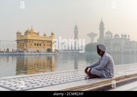 Amritsar, Inde - 21 novembre 2011 : le pèlerin sikh médite sur le lac Amrit Sarovar, dans le complexe du Temple d'Or. Amritsar, Punjab, Inde. Banque D'Images