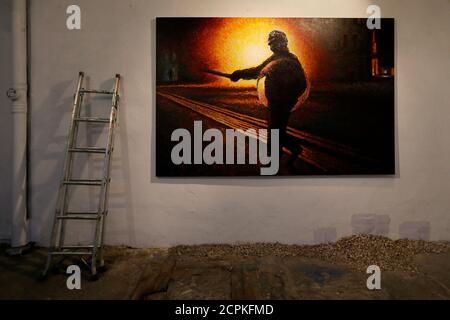 The spray painted picture 'Defy' by Street artist James Cochran, also known as Jimmy C, is seen at the Pure Evil Gallery in London October 10, 2013. The paintings were originally inspired by the London riots in 2011. REUTERS/Stefan Wermuth (BRITAIN - Tags: ENTERTAINMENT SOCIETY)