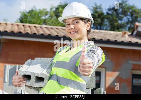 Montre Femme builder thumb up Banque D'Images