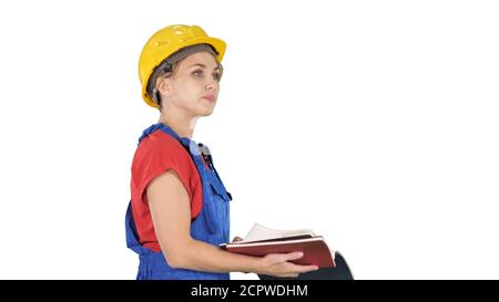 Femme travailleur de la construction en casque de sécurité et en tenue de travail contrôle uniforme Banque D'Images