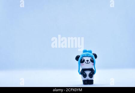 Petite figurine en porcelaine panda isolée sur fond noir Banque D'Images