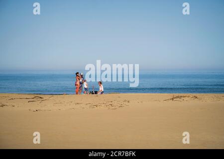 Famille sur la plage de Narbonne Plage en été Banque D'Images