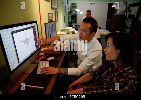Eason Zhou 28 Mother Of A 5 Year Old Child Checks A Tattoo Design On A Computer With Her Tattoo Artist Shi Hailei At Samurai Tattoo In Shanghai China April 25 17 Zhou Underwent