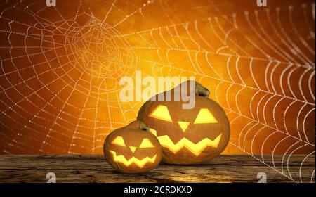 un arrière-plan effrayant pour halloween avec des citrouilles à sourire et une toile d'araignée Banque D'Images