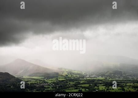 Belle image de paysage à travers la vallée de Derwentwater avec chute de pluie dérivant de l'autre côté des montagnes, sur la campagne verdoyante ci-dessous Banque D'Images