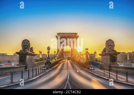 Budapest Hongrie, vue sur la ville se lever au pont des chaînes avec la célèbre statue du lion Banque D'Images