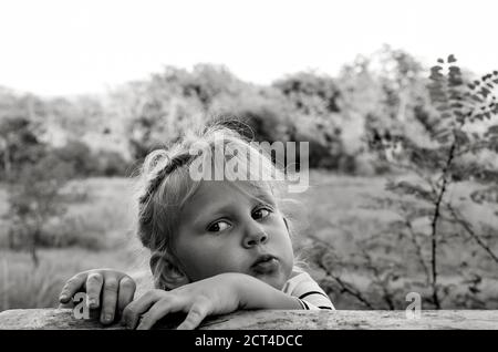 Gros Plan Portrait Noir Et Blanc De Joli Beau Bebe Caucasien Les Emotions Sinceres Des Enfants Moments D Enfance Fille Pres D Une Table En Bois A La Nature Photo Stock Alamy