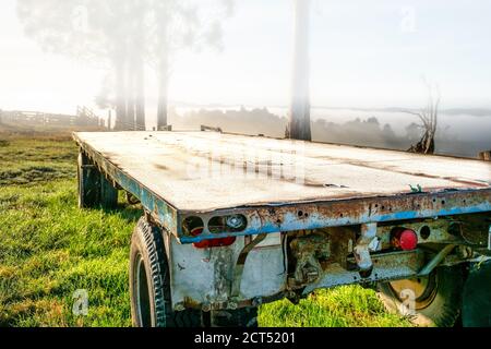 Remorque de ferme recouverte de gel au lever du soleil dans les collines rurales De Berwick sur un froid gelé jour avec peu de brume et brouillard qui traverse les vallées Banque D'Images