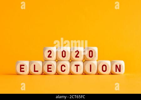 Le mot élection 2020 écrit sur des blocs de bois sur fond jaune. Concept d'élection présidentielle aux États-Unis. Banque D'Images