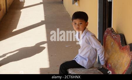 KOH SDACH, CAMBODGE - le garçon se trouve devant sa salle de classe à l'école primaire (10 janvier 2017) Banque D'Images