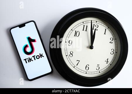 Stafford / UK - septembre 21 2020: TikTok et l'horloge, concept. Logo TikTok vu sur le smartphone et le compte à rebours analogique à côté. Banque D'Images