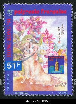 POLYNÉSIE FRANÇAISE VERS 1994: Timbre imprimé par la Polynésie française, montre chien, buisson en fleur, Hong Kong, vers 1994 Banque D'Images