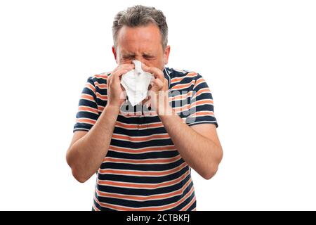 Gros plan d'un modèle masculin adulte portant une tenue d'été tendance éternuant couvrant la bouche et le nez avec du tissu blanc comme covid19 malade concept de grippe froide isol Banque D'Images