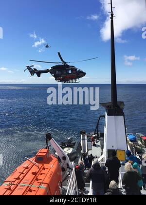 Sauvetage d'urgence en cas d'évacuation par hélicoptère dans les îles d'Auckland lors d'une croisière d'expédition, un autre hélicoptère de secours en arrière-plan, pour des raisons de sécurité Banque D'Images
