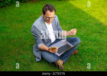 Happy Adult masculin développeur test application mobile, vue de dessus, espace de copie Banque D'Images