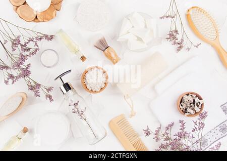 Accessoires écologiques frais et cosmétiques pour la salle de bains avec brindilles et décorations lavande élégantes sur fond blanc, vue du dessus. Banque D'Images