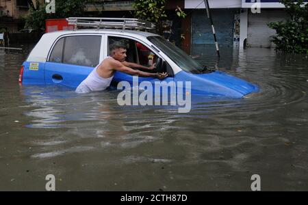 Mumbai, Inde. 23 septembre 2020. Un homme pousse tente de pousser sa voiture sur une route en eau.de fortes pluies ont heurté la ville, entraînant l'engorgement et les gens ayant de la difficulté à faire à travers les eaux inondées. Crédit : SOPA Images Limited/Alamy Live News Banque D'Images