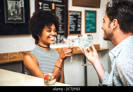 Un couple heureux vous fera griller des boissons au comptoir du bar Banque D'Images