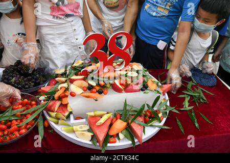 Les gens font un gâteau pour Xin Xing, un panda captif de 38 ans et le plus ancien au monde, dans la maison de panda à Chongqing, en Chine, le 15 août 2020. Banque D'Images