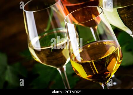 Ensemble vin blanc. Dégustation de vins, les variétés de vins blancs les plus populaires dans des verres à vin sur une table en bois vintage dans un style rustique, concentration sélective Banque D'Images