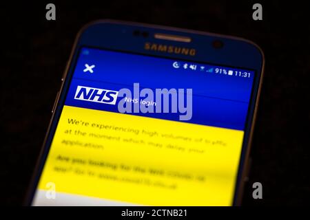 L'application NHS Track and Trace sur l'écran de Un téléphone mobile Android avec un message à volume élevé du trafic peut retarder votre application Banque D'Images