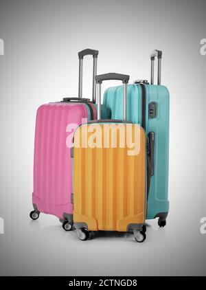 Valises multicolores isolées sur fond gris Banque D'Images