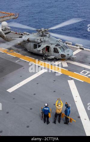 200905-N-QM905-1143 MER DE CHINE MÉRIDIONALE (SEPT 5, 2020) les marins affectés au navire d'assaut amphibie déployé à l'avant USS America (LHA 6) préparent un hélicoptère MH-60S Sea Hawk affecté au détachement 6 de l'Archanges de l'Escadron de combat de la mer (HSC) 25 pour le lancement. L'Amérique, navire chef de file du America Amphiobie Ready Group, affecté au Squadron amphibie 11, avec la 31e unité expéditionnaire maritime, Opère dans la zone de responsabilité de la 7e flotte des États-Unis afin d'améliorer l'interopérabilité avec les alliés et les partenaires et de servir de force de réaction prête pour défendre la paix et la stabilité dans l'Indo- Banque D'Images