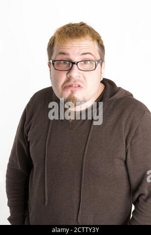 Perplexe Homme avec lunettes et sweatshirt marron Banque D'Images