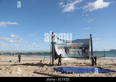 L'installation commence sur la plage de Boscombe, à Bournemouth, pour l'œuvre de Steve, un satiriste de la Guerre froide, une coupe-vent courbe de 25 mètres représentant une scène de la plage de Bournemouth, dans le cadre du festival Bournemouth Arts by the Sea 2020. Banque D'Images