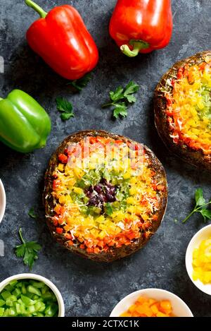 La cloche de légumes Rainbow piments pizza croûte sur fond de pierre bleue. Végétalien végétarien ou concept de nourriture saine. Vue sur le dessus, plat Banque D'Images