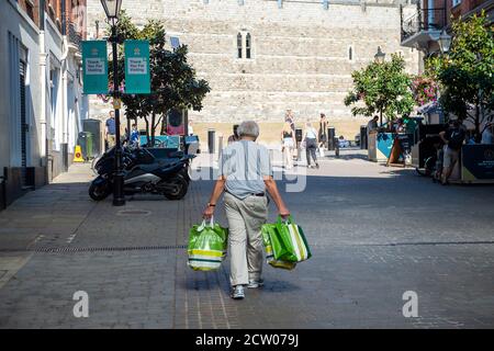 Windsor, Berkshire, Royaume-Uni. 10 août 2020. Un homme porte son magasin dans des sacs de transport de Waitrose à Windsor dans un après-midi d'été très chargé alors que la vague de chaleur continue. Crédit : Maureen McLean/Alay Banque D'Images