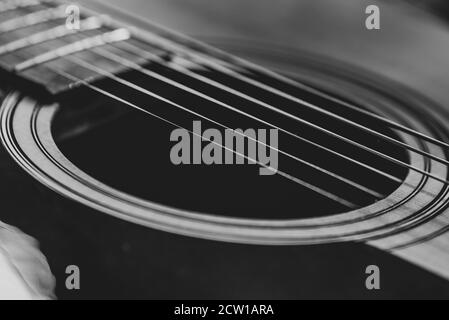 Détails d'une guitare acoustique, photos détaillées d'une guitare, cordes de guitare et son trou, abstrait, flou, macrophoto, noir et blanc Banque D'Images