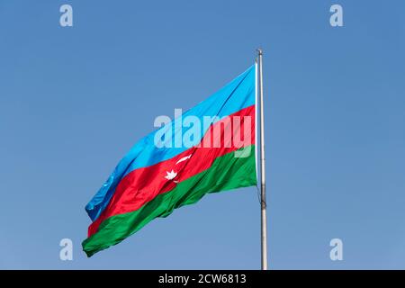 Azerbaïdjan drapeau contre ciel bleu. Drapeau national de l'Azerbaïdjan sur un vent fort dans la journée ensoleillée Banque D'Images