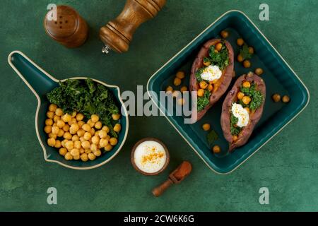 Patate douce cuite au four, remplie de kale et de pois chiches . Vue de dessus avec espace de copie Banque D'Images