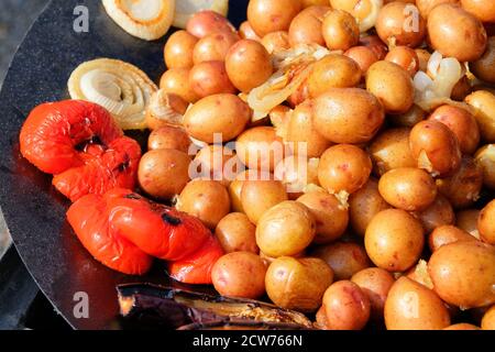 Pommes de terre grillées servies dans une poêle en métal, plats à emporter végétaliens. Cuisine de fête de rue. Banque D'Images