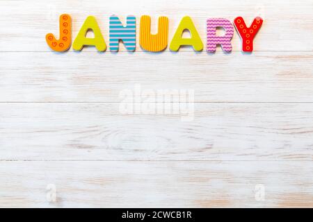 Lettres en bois écrites le mois de janvier sur fond vintage. Inscription janvier avec espace copie. Vue de dessus. Maquette pour les événements de calendrier. Un de 12 mois Banque D'Images