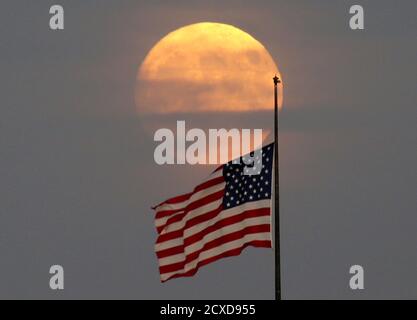 Jersey City, États-Unis. 30 septembre 2020. Une lune presque pleine s'élève derrière un drapeau américain à Jersey City le mercredi 30 septembre 2020. Photo de John Angelillo/UPI crédit: UPI/Alay Live News Banque D'Images