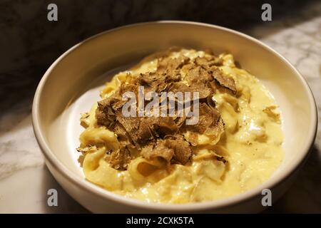 Gros plan sur une truffe noire en tranches recouverte de spaghetti Carbonara Banque D'Images