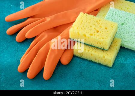 Gants en caoutchouc avec éponges de cuisine colorées, entretien ménager. Concept de service de nettoyage, travaux ménagers. Épurateur de vaisselle Banque D'Images